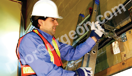 Door Surgeon technician working on replacing an overhead door spring Chestermere.
